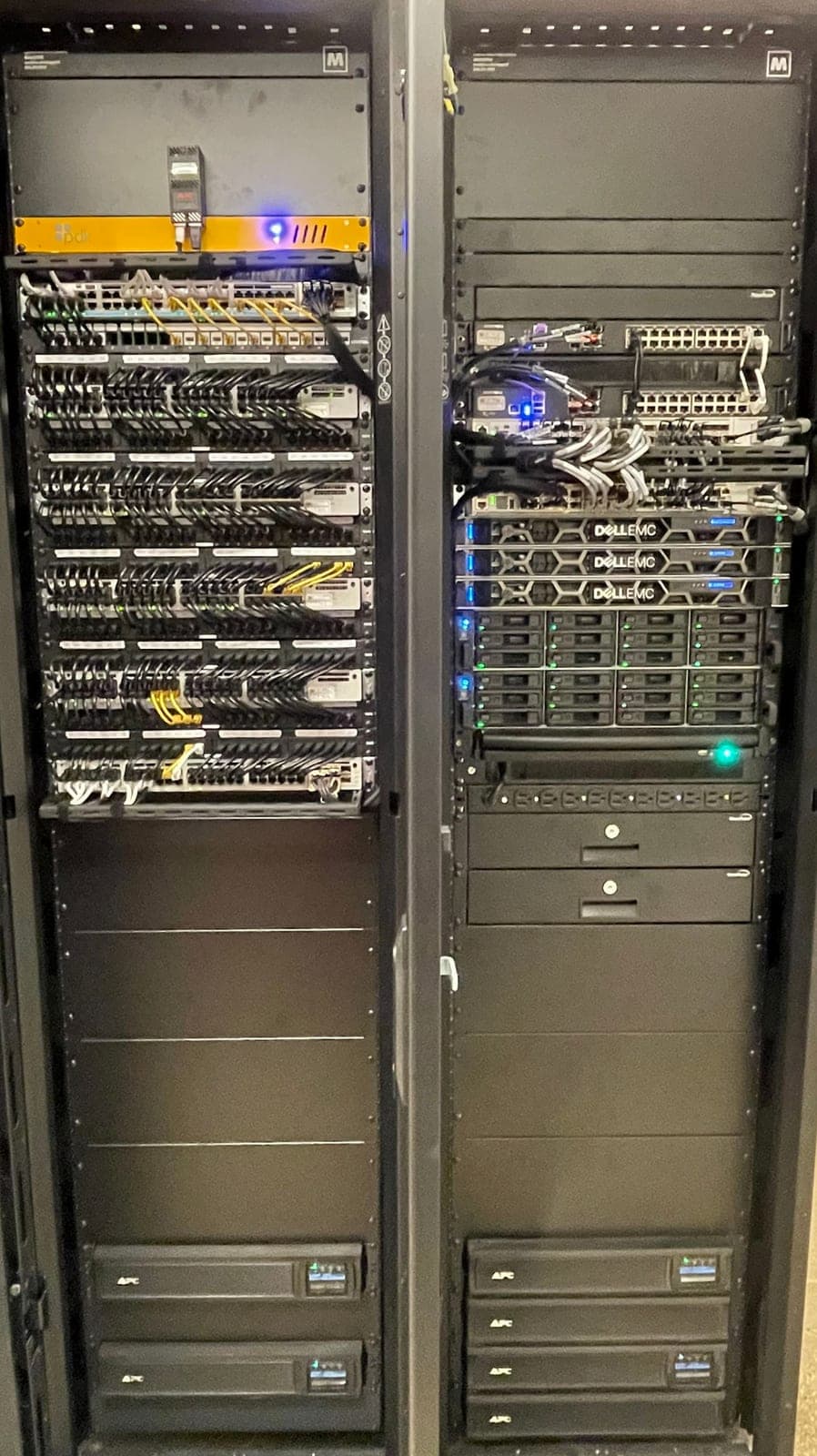 Server rack at Pembrooke & Ives — Dell PowerEdge cluster, Cisco switching, and SAN storage