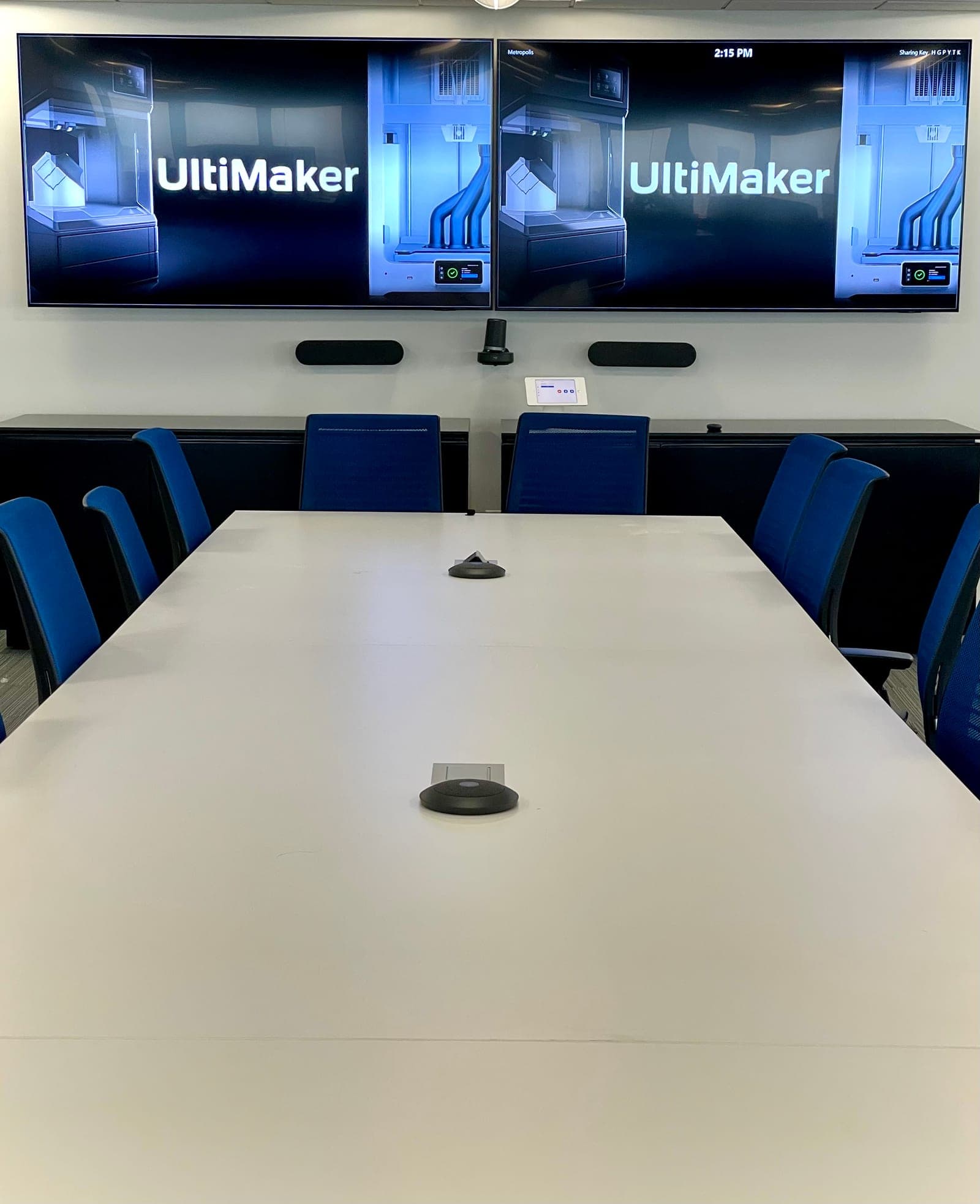 UltiMaker's board room Zoom Room — dual displays, table microphones, and a tabletop controller — at its new 55 Water Street headquarters