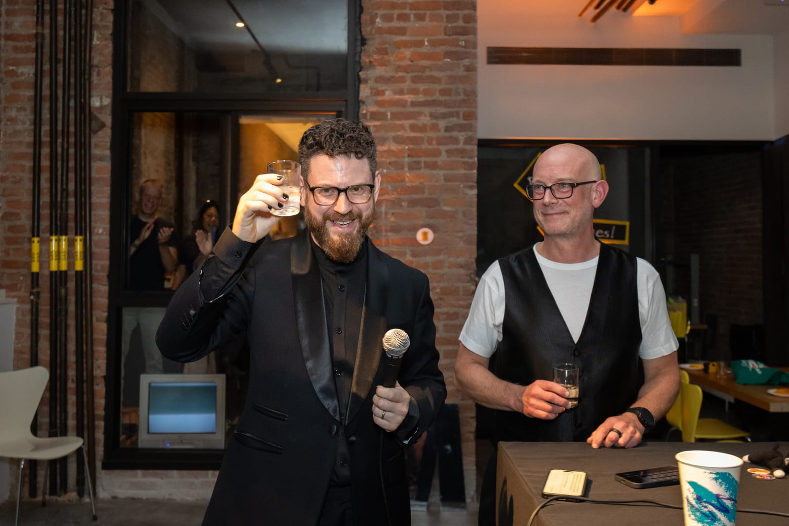 Macktez co-founders Noah Landow and Michael Horst raise a toast to close out the night, Noah holding a microphone
