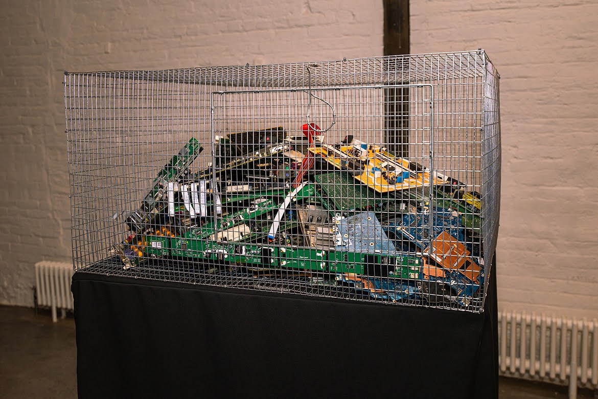 Wire cage filled with a heap of circuit boards and electronic components