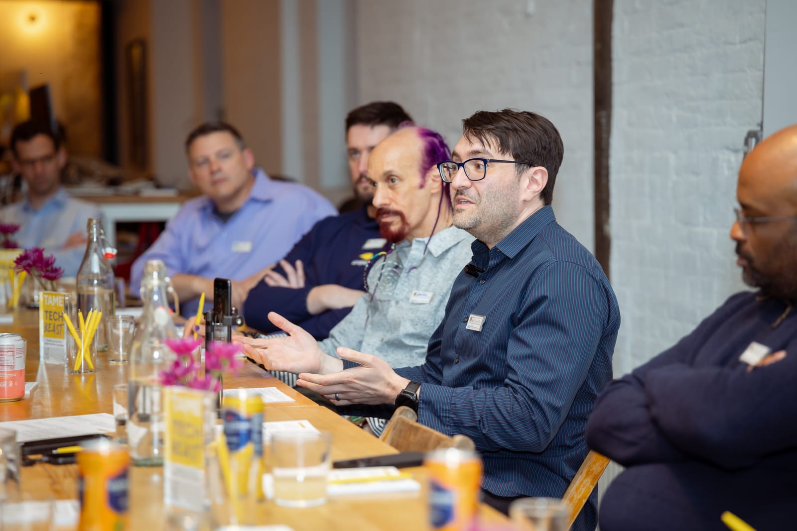 Jeffrey Berger, Ph.D. speaking at the table during the AI and Consciousness Tête-à-Tech, with attendees listening