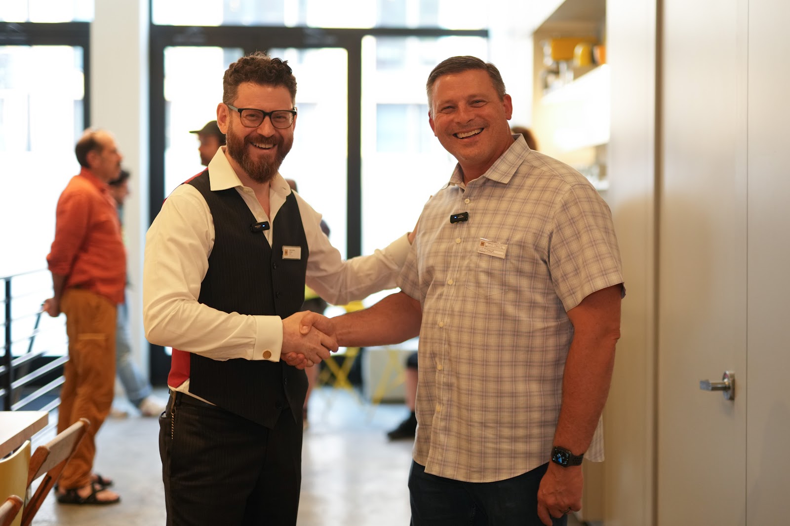 Noah Landow and Jim Franz shaking hands in the Macktez office before the Modern Alchemy Tête-à-Tech