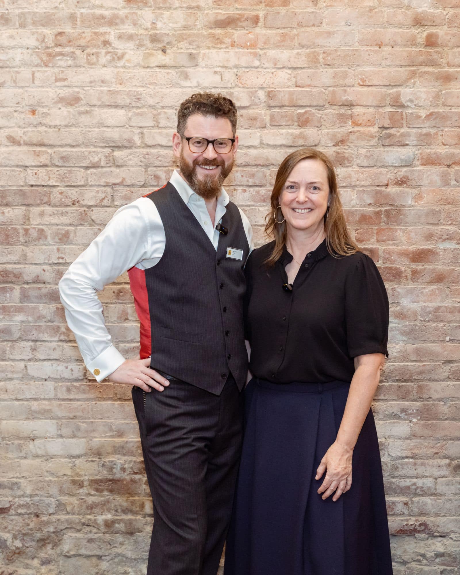 Noah Landow and Francine Snyder standing together against a brick wall before the Tête-à-Tech event