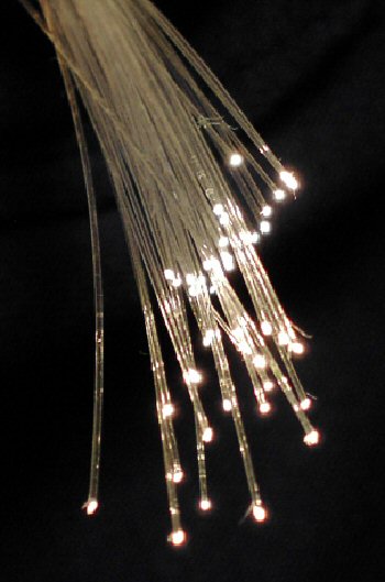 Diagram showing total internal reflection — light ray bouncing inside fiber optic core at angles below the critical angle